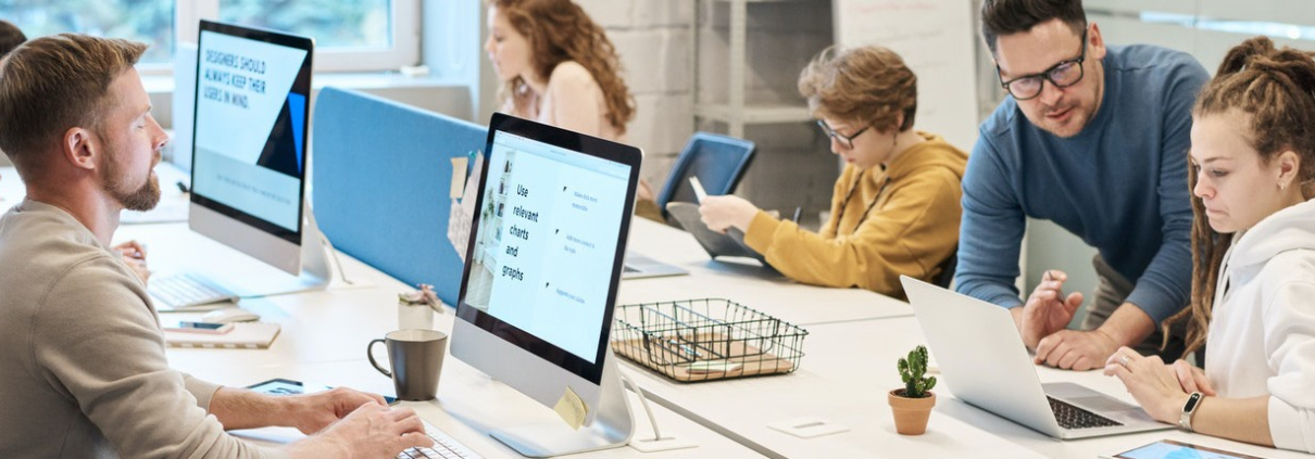 Workers at desks in a clean, modern open office space