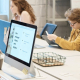 Workers at desks in a clean, modern open office space