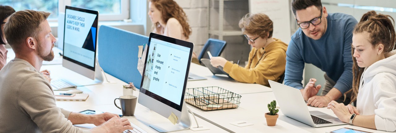 Workers at desks in a clean, modern open office space