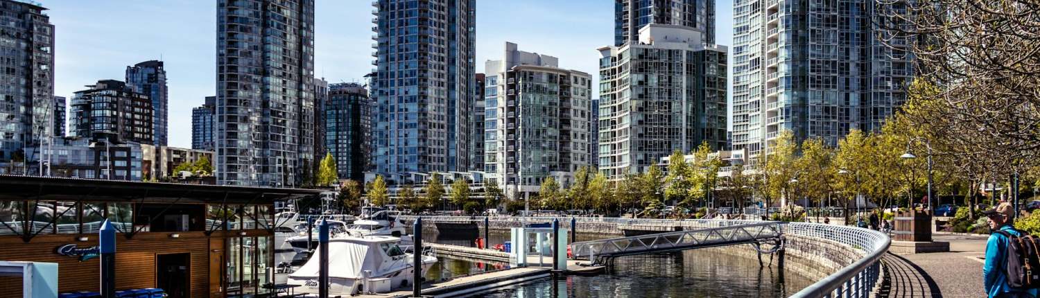 A modern urban waterfront with high-rise residential buildings in the background